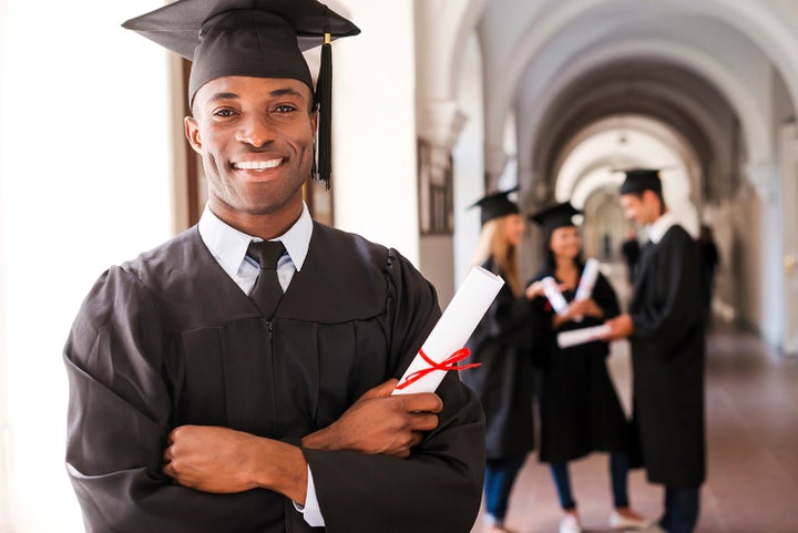 college graduate holding his diploma | Sunset Hills Subaru in Sunset Hills MO