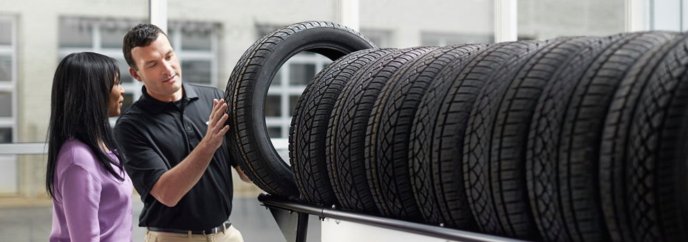 Subaru service representative showing customer a tire. | Sunset Hills Subaru in Sunset Hills MO